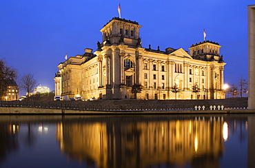 Reichstag, German parliament building reflected in the Spree River in the evening, Berlin, Germany