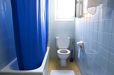 Bath, shower curtain and toilet in a bathroom