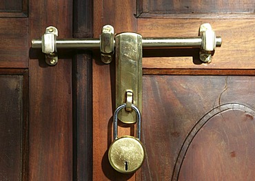 Latch with padlock on a wooden door