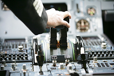 Pilot in cockpit of an Airbus A319, take off, engine power