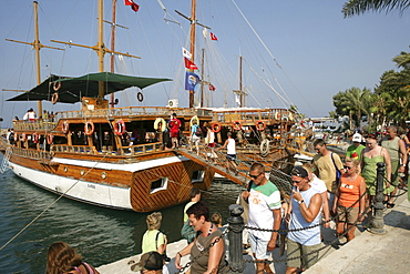 TUR Turkey Side Turkish riviera coast. Tourist entering a boat for a day trip excursion