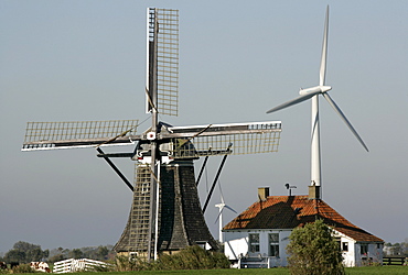 Baburenmolen historic windmill with modern wind turbines in background, Bolsward, Friesland, The Netherlands, Europe