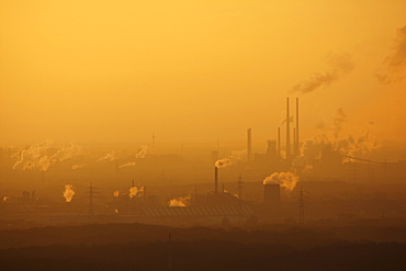 Hazy view of the Thyssen-Krupp steelworks at Hamborn, Schwelgern at sunset, near Duisburg, North Rhine-Westphalia, Germany, Europe