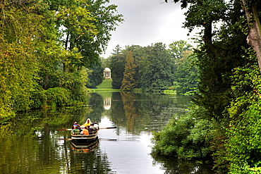 Rowboat going across the lakes and canals at Schoch's Garden, Kleines Walloch watercourse and the Venus Temple, Dessau-Woerlitz Garden Realm, UNESCO World Heritage Site, Dessau, Saxony-Anhalt, Germany