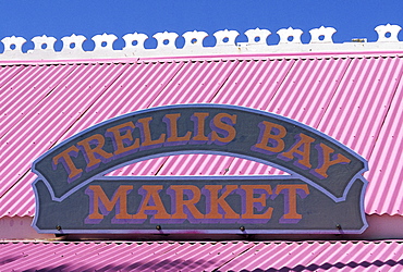 Sign on a pink tin roof at a small supermarket on Beef Island, British Virgin Islands, Lesser Antilles, Caribbean