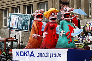 Knife impaling three paper-mache figures, its hilt a Nokia phone, political caricature, Carnival (Mardi Gras) parade in Duesseldorf, North Rhine-Westphalia, Germany, Europe