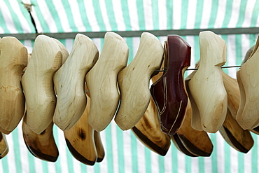 Wooden clogs hanging in a tent on a rod, traditional craft market, Flachsmarkt Burg Linn, Krefeld, Lower Rhineland, North Rhine Westphalia, Germany, Europe