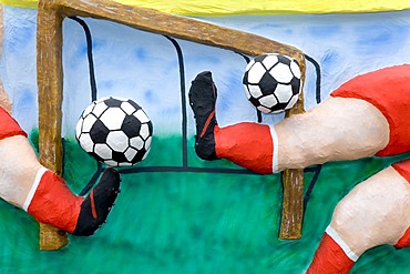 Two footballers are shooting simultaneously two balls, caricature made of paper mache , monday before lent parade, Duesseldorf, NRW, Germany