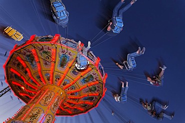 Chairoplane riding at nightfall, Rhine fair, Duesseldorf, NRW, Germany