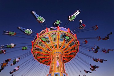 Chairoplane riding at nightfall, Rhine fair, Duesseldorf, NRW, Germany