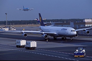 Airport , Lufthansa Airbus on the way to the start position, background Jumbo Jet in landing situation