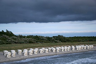 Rain clouds over beach chairs on a beach of the Baltic Sea in Fischland, Mecklenburg-Western Pomerania, Germany