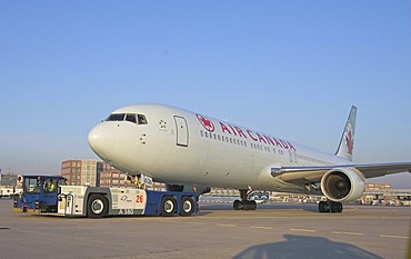 Goldhofer aeroplane tractor AST-1 X drags an airbus from Air Canada, Airport Frankfurt, Germany