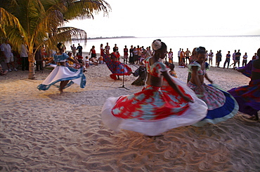 Local dancers performing a dance on a beach at dusk, Mauritius, Mascarenes, Indian Ocean