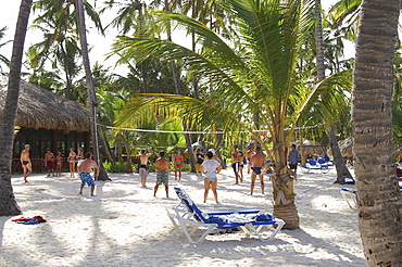 Tourists playing beach volleyball at an all-inclusive resort as part of the its organized activities program in the Dominican Republic, Caribbean, Americas