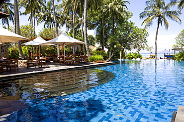 Swimming pool complex and terrace restaurant of the Sheraton Hotel near Senggigi, Lombok Island, Lesser Sunda Islands, Indonesia