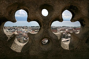 View through the balustrade to the roofs of Lausanne downtown. Tower on 11th century Cathedral Notre-Dame, Lausanne, Waadt, Switzerland