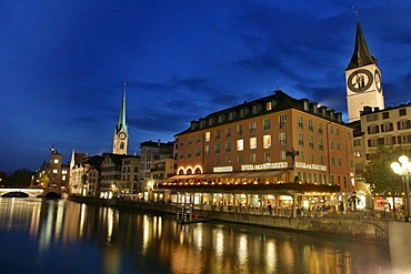 Saint Peter Church, Fraumunster and the lights of the old town reflecting in the Limmat, Zurich, Switzerland