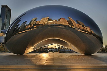 Cloud Gate at sunrise on Lake Michigan shore in front of the Chicago skyline, Illinois, USA