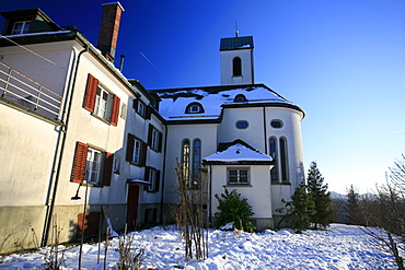 The Church of St. Iddaburg is sitting on the hill where the old Toggenburg castle stood high above Kirchberg village, St. Gallen, Switzerland