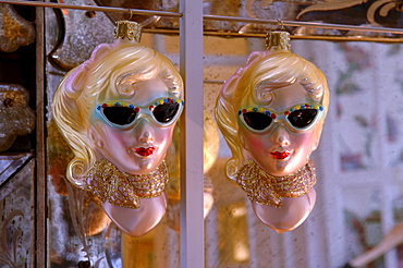 Retro ornaments from the 1950s featuring two blonde women wearing sunglasses and scarves