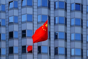 National flag blowing in the wind in front of the facade of the Chinese embassy, Berlin, Germany, Europe