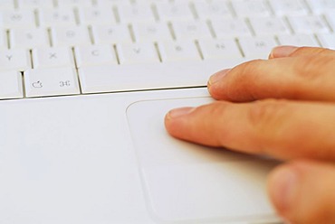 Hand on notebook keyboard