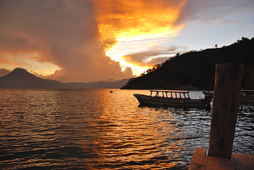 Sunset, back light, dramatic clouds, boat, Lake Atitlan, Guatemala, Central America