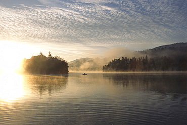 Fisherman on Reintalersee (Reintal Lake) at sunrise, North Tirol, Austria, Europe