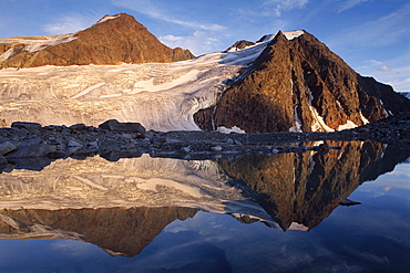 Mt. Schwarze Schneid reflected on the surface of an alpine lake in the Oetztal Alps, North Tirol, Austria, Europe