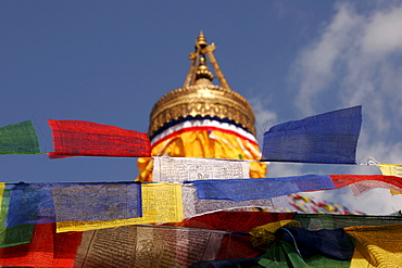 Red, yellow, white, blue and green prayer flags at the Bodnath stupa, accompanied by traditional Tibetan prayer verses "Om mani padme hum, " which are said to be carried throughout the world by the wind, Kathmandu, Nepal, Asia