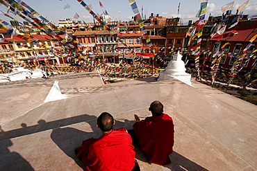 Buddhist monks at the stupa of Bodnath, a northeastern suburb of Kathmandu, Nepal, Asia