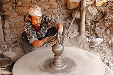 Potter at work on an outdoor pottery square in Bhaktapur, Nepal