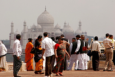 Indian tourists visiting the Red Fort of Agra, with the Taj Mahal in the background, Agra, Uttar Pradesh, India, Asia