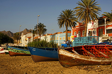 Rowboats pulled onto the beach in front of the coastal promenade of Mindelo on Sao Vicente Island, Cape Verde Islands, Cape Verde, Africa