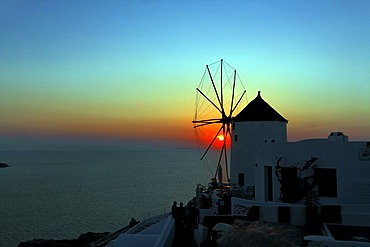 Mill with sunset in Oia in Santorin in the Aegean, Greece