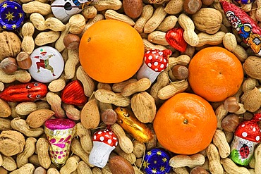 Different sorts of nuts with christmas chocolate and tangerines