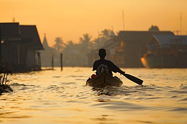 Man in boat on distributary of Sungai Barito near Banjarmasin, South-Kalimantan, Borneo, Indonesia