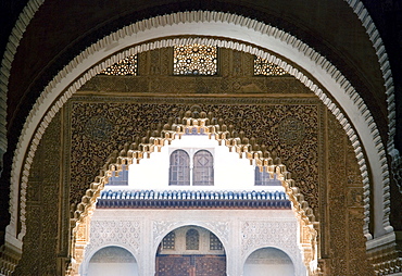 Highly ornate Moorish arches, intricate wood carving in the Alhambra fortress, Granada, Andalusia, Spain