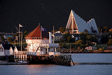 Harbour in front of modern triangular Christian church, Ishavskatedralen (Arctic Cathedral aka Tromsdalen Church), Tromsoe, Norway