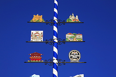 Maypole with signs of Neuschwanstein and Hohenschwangau, Schwangau near Fuessen, Bavaria, Germany