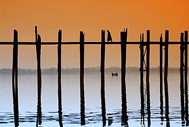 Monks crossing the U Bein Bridge at sunset, old wooden teak bridge, Mandalay, Myanmar, Southeast Asia