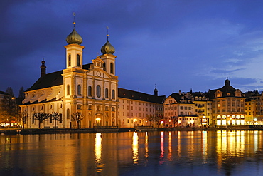 Lights of the St. Francis Xavier Jesuit Church reflected on the surface of the Reuss River, Lucerne, Switzerland