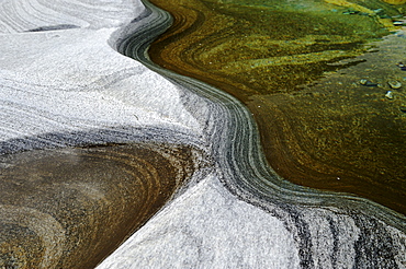 Rock ground by water in Valle Verzasca Valley, The Tessine, Switzerland, Europe