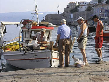 Port harbour fisherman selling his catch fresh off the boat Hydra Saronic island Greece