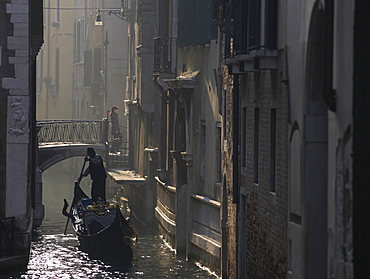 Gondolier in morning mist, Venice, Italy, Europe