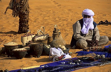 Touareg sitting in the sand selling souvenirs, Libya