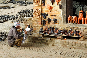 Man reading a newspaper in front of a souvenir shop, Bhaktapur, Nepal