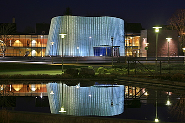 New music school reflected in a pond at dusk, unique architecture, Fellbach, Stuttgart, Baden-Wuerttemberg, Germany