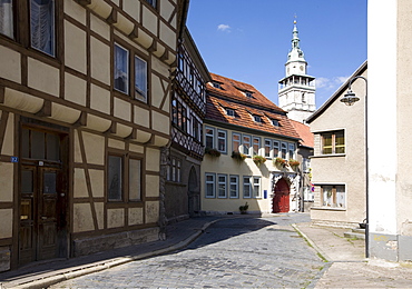 Fachwerk-style half-timbered houses in the historic city centre and the tower of St. Boniface's Church in the background, Bad Langensalza, Thuringia, Germany, Europe